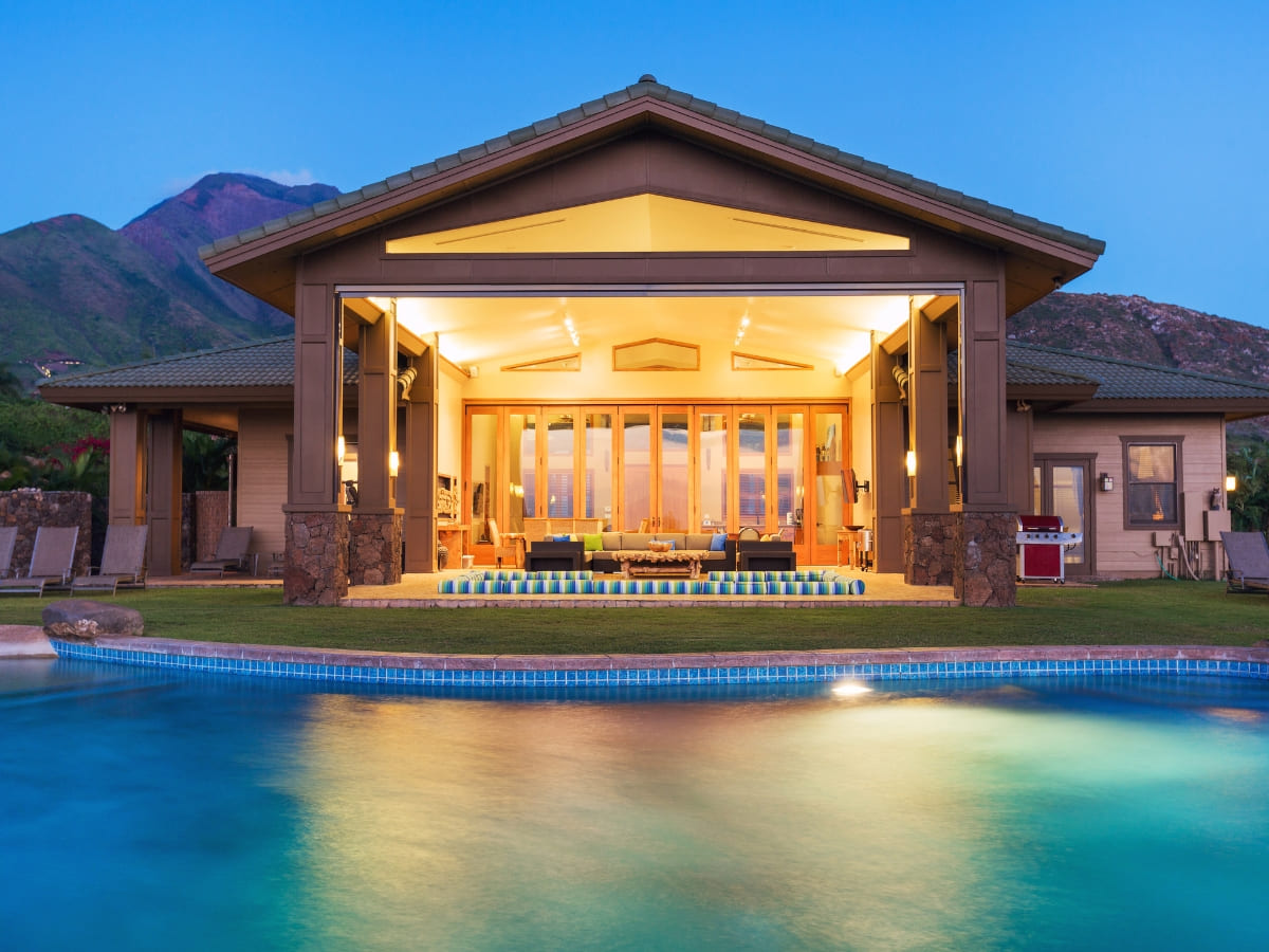 Luxury pool with evening lighting reflecting a modern, open-concept home in Baldwin.