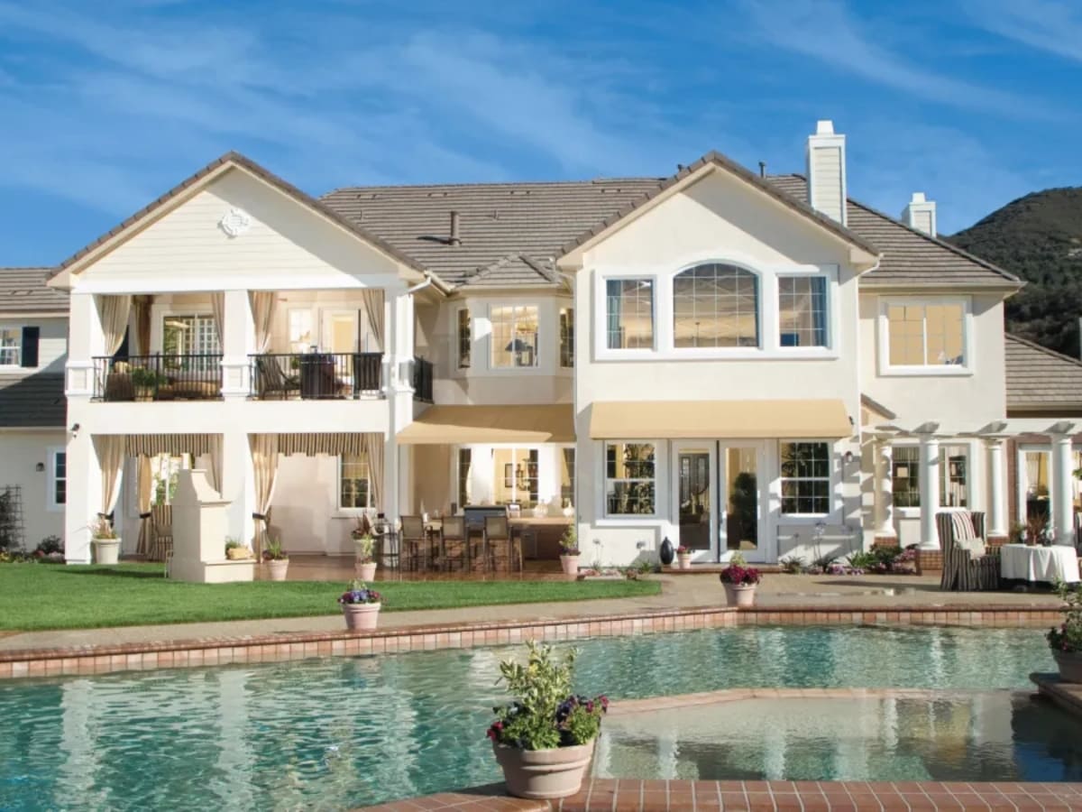 Beautifully renovated pool with a spacious outdoor area and a luxurious two-story home in Baldwin.