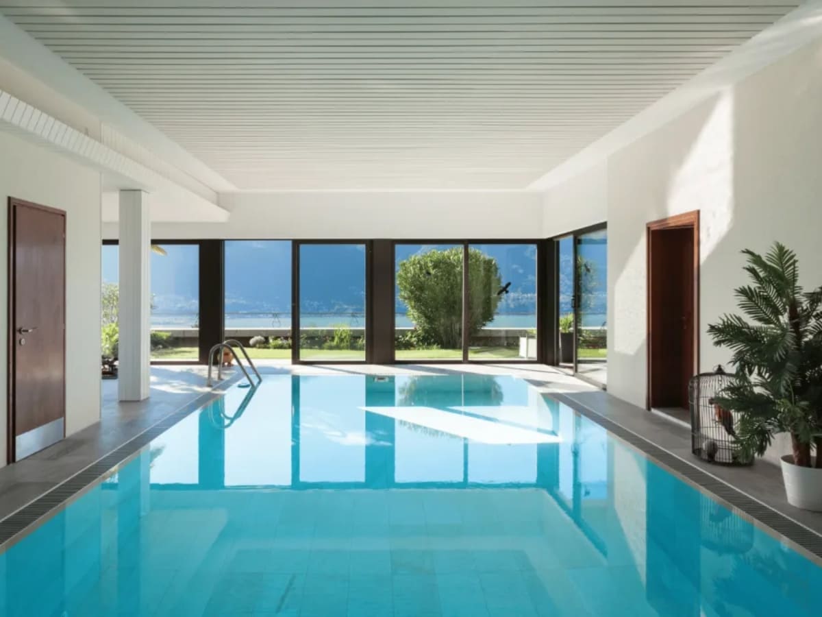 Indoor pool with large windows offering scenic views, creating a serene environment in Baldwin.
